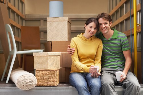 Professional movers carrying furniture through a Danish apartment building