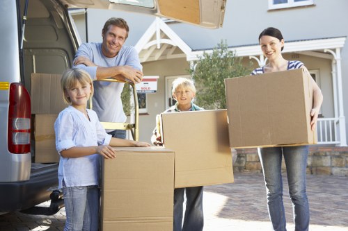 Packed boxes and furniture ready for transport with a moving truck in Denmark