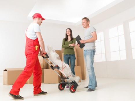 House removal truck and moving team in a residential Denmark street