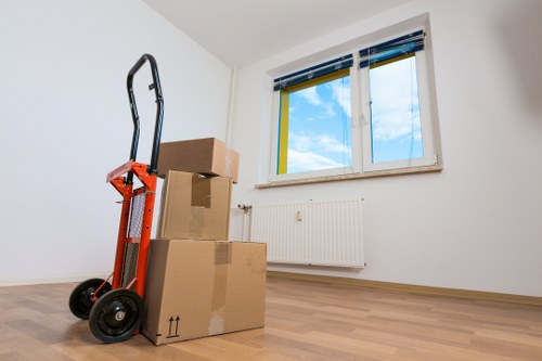 Packed moving boxes and furniture in a Danish home relocation