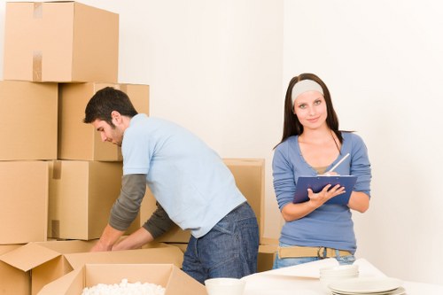 Local movers handling household furniture in a Danish townhouse