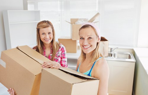 Packed boxes, wrapped furniture, and moving supplies ready for a Denmark house move