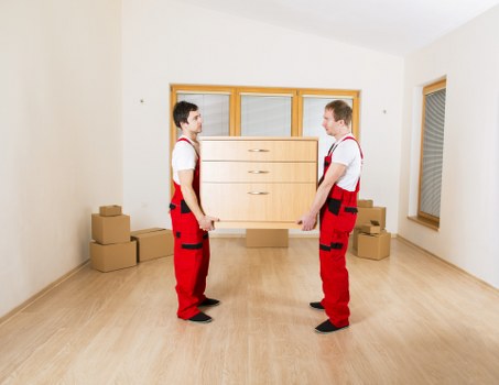 Local movers preparing furniture for transport in a Danish city